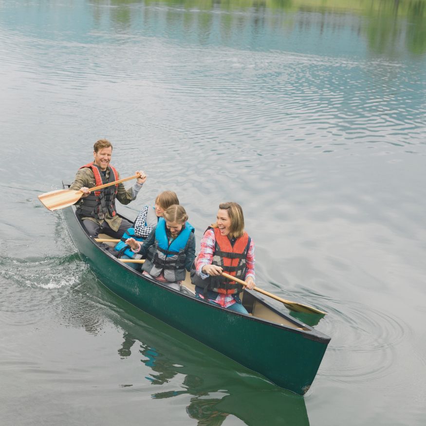 family canoe on lake